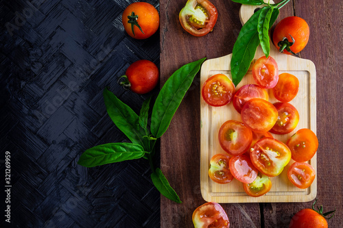 Tomato background cut in half on a wooden background