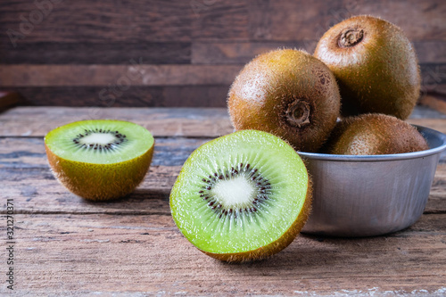 .Fresh kiwi fruit in bowl on table