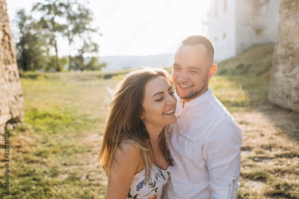 Candid photo of happy laughing young couple enjoy life together with natural outdoor laisure activity lifestyle outside during the summer and the sunset in backlight Candid photo of happy laughing young couple enjoy life together with natural outdoor laisure activity lifestyle outside during the summer and the sunset in backlight