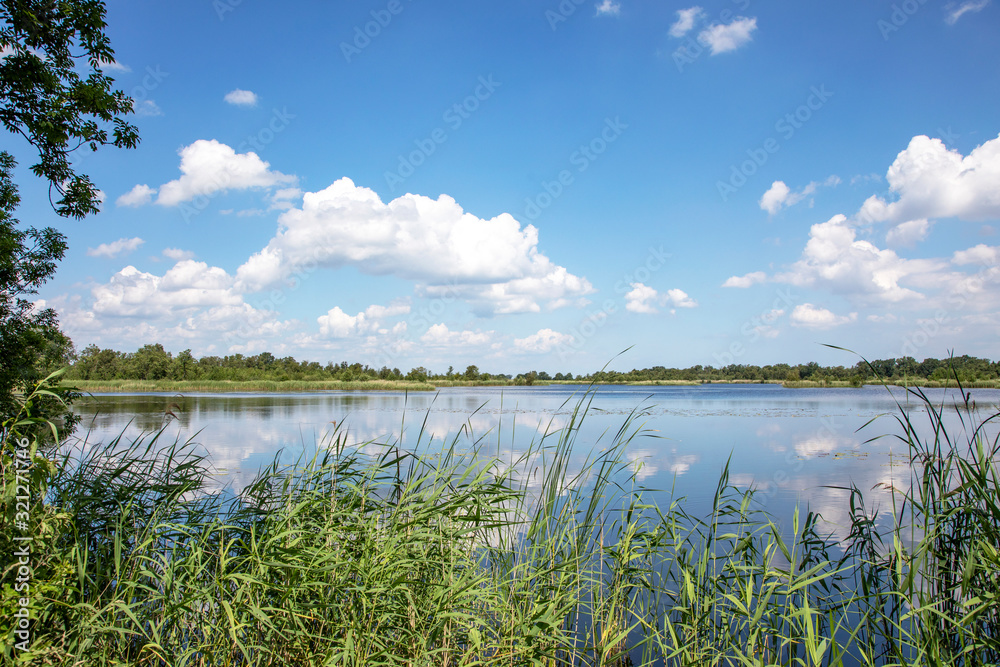 Ankeveen, the Ankeveense Plassen are a maze of pet holes and layers, jumble of islands, narrow ditches and open water. A beautiful sky reflection in the water. Ankeveen, the Ankeveense Plassen are a maze of pet holes and layers, jumble of islands, narrow ditches and open water. A beautiful sky reflection in the water.