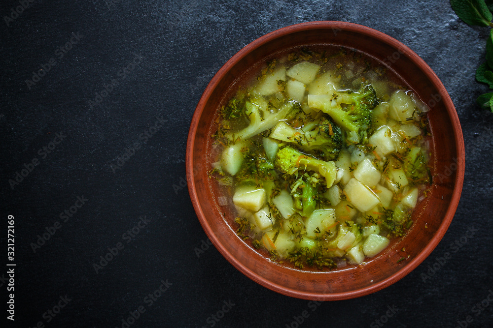 soup broccoli, broth and other vegetables (vegetarian first course) menu concept. background. top view. copy space soup broccoli, broth and other vegetables (vegetarian first course) menu concept. background. top view. copy space