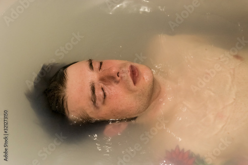 man relaxing on a bathtub