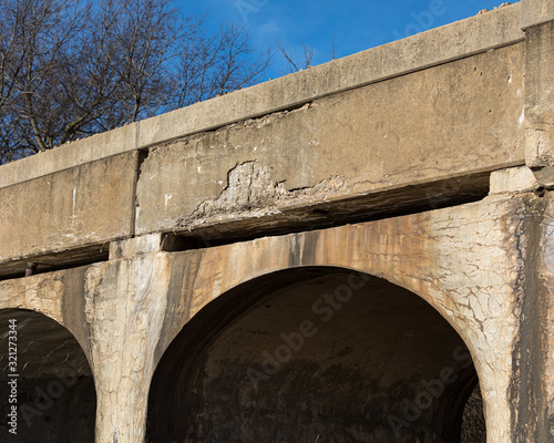 фотографія Old rural railroad bridge with crumbling, cracking concrete