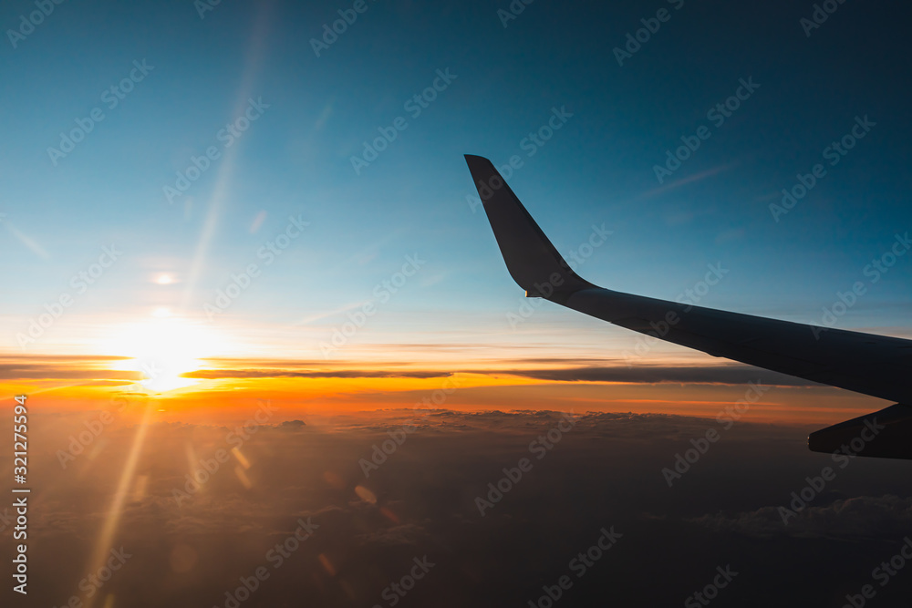 Airplane flying above the clouds at sunset. Airplane flying above the clouds at sunset.