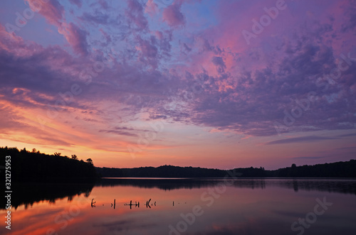 Landscape at sunrise Pete's Lake with beautiful reflections in calm water, Hiawatha National Forest, Michigan's Upper Peninsula, USA photo