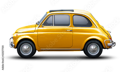 Small retro car of yellow color, side view isolated on a white background. photo