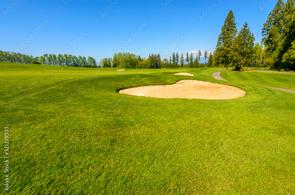 Fototapeta premium Golf course with gorgeous green and sand bunker