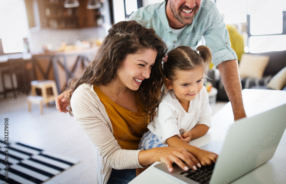 Happy family spending time at home and using laptop Happy family spending time at home and using laptop