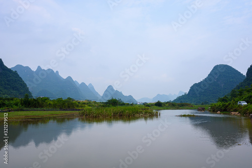 Beautiful karst mountains landscape and the Yulong river in Yangshuo County, Guilin, China © munettt