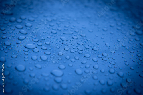 Hundreds and thousands of beaded water droplets on a gloss Blue color surface.