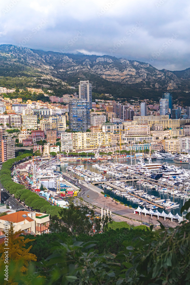 Cityscape, apartments of Monte Carlo, Monaco. Cityscape of La Condamine, Monaco-Ville, Monaco. Principality of Monaco, French Riviera. Houses and buildings on hills background view aerial. Vertical