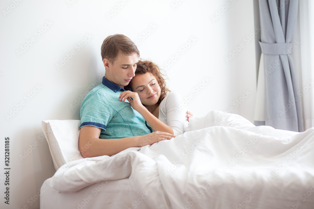 Fototapeta premium Romantic love couple make love scene on white bed