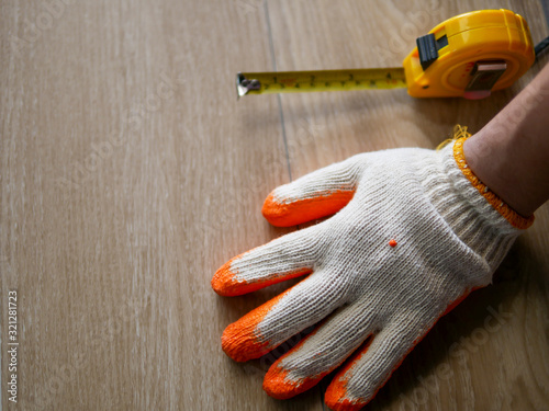 vinyl tile flooring collection : handyman hand on vinyl sheet to installing floor tile 