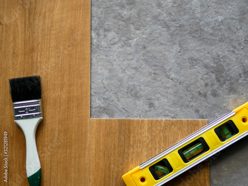 Luxury vinyl floor tiles collection : top view over vinyl sheet installing on cement floor to renovate site 