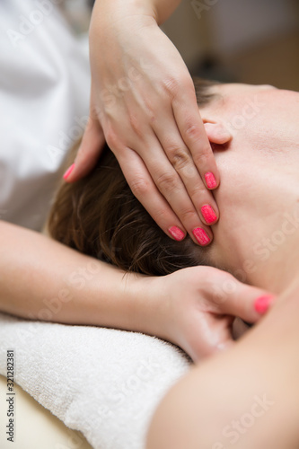 Woman getting a stress relieving pressure point massage on her neck by a health therapist