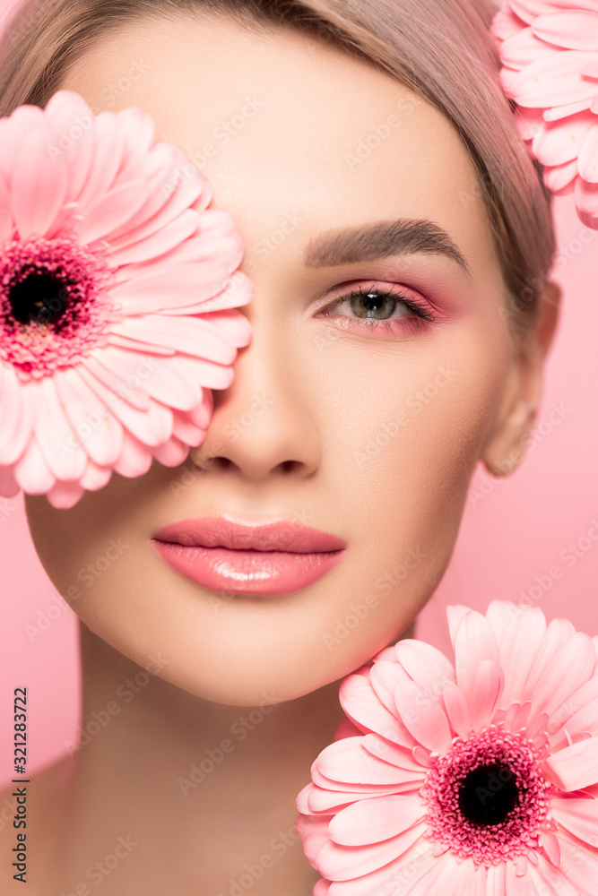 beautiful girl with pink makeup and gerbera flowers, isolated on pink beautiful girl with pink makeup and gerbera flowers, isolated on pink
