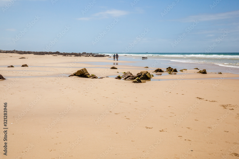 Old couple hiking along the beach of Cape St Francis Old couple hiking along the beach of Cape St Francis