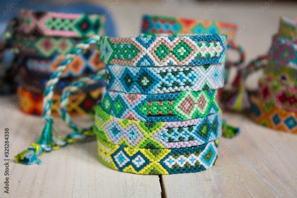 close-up isolated lots of colorful variety bracelets of handmade