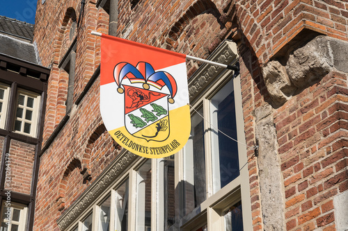 Dutch flag, in red, white and yellow, of traditional festival named Carnaval, like Mardi Gras, in 's-Hertogenbosch, Oeteldonk hanging on a building photo