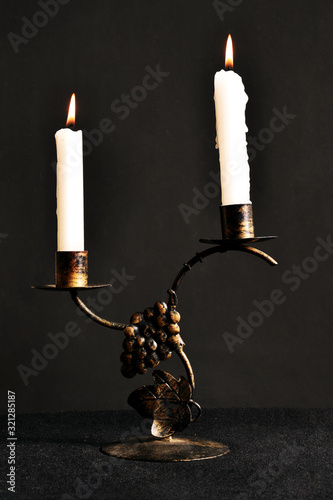 burning candle on black background