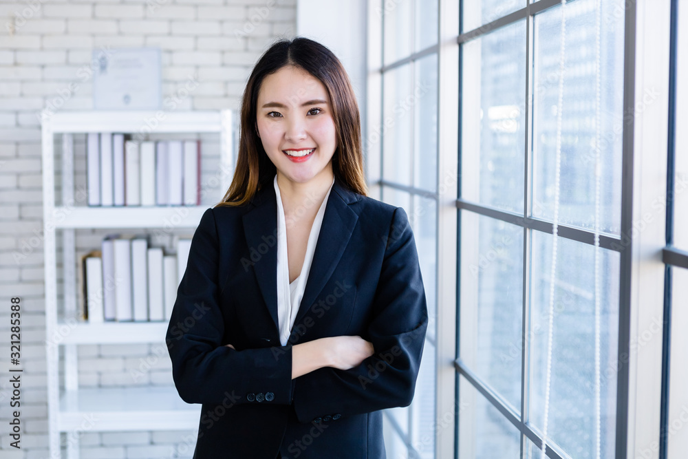 Portrait of a cheerful mature Asian businesswoman at In the office room background,business expressed confidence embolden and successful concept Portrait of a cheerful mature Asian businesswoman at In the office room background,business expressed confidence embolden and successful concept