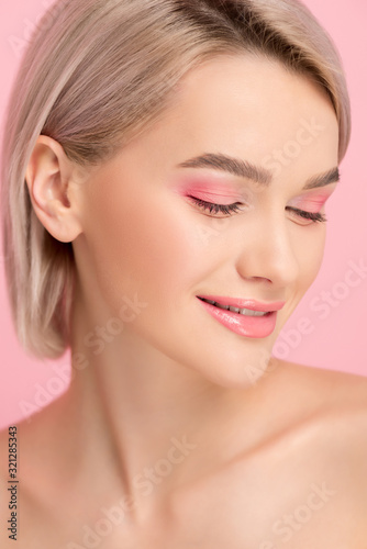 beautiful smiling girl with pink makeup, isolated on pink
