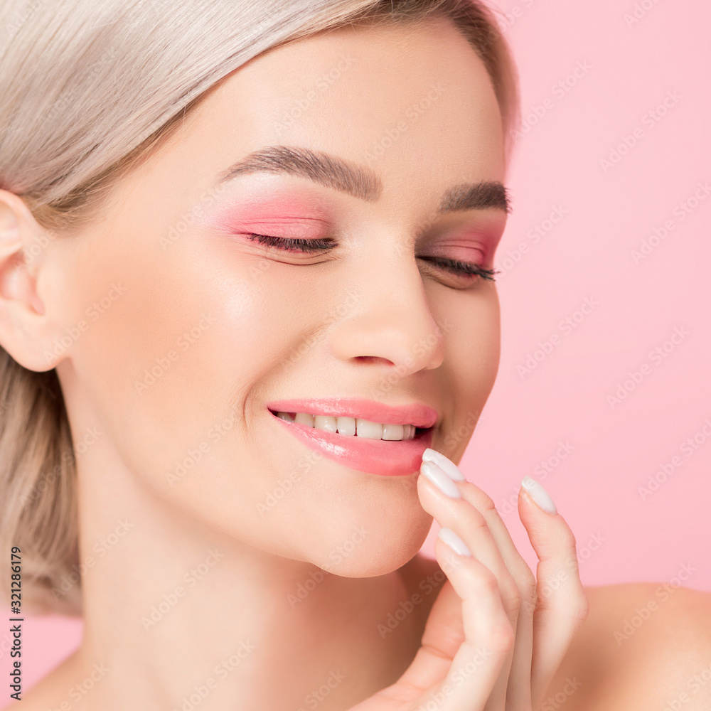 beautiful smiling girl with pink makeup touching lips, isolated on pink beautiful smiling girl with pink makeup touching lips, isolated on pink