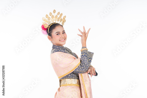 A beautiful Malaysian traditional female dancer wearing traditional dance outfit. Half length portrait isolated in white. Landscape orientation. photo