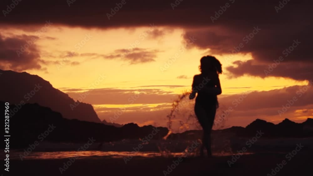 Unrecognisable woman sexy running in the sea to the camera sea splashes waves crashing againnst her legs red sunset dramatic sky relax enjoying travel rocks stones cloudy romantic evening slow motion Unrecognisable woman sexy running in the sea to the camera sea splashes waves crashing againnst her legs red sunset dramatic sky relax enjoying travel rocks stones cloudy romantic evening slow motion