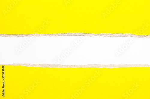 Yellow torn pieces of cardboard paper on white background. Copy space for text message.