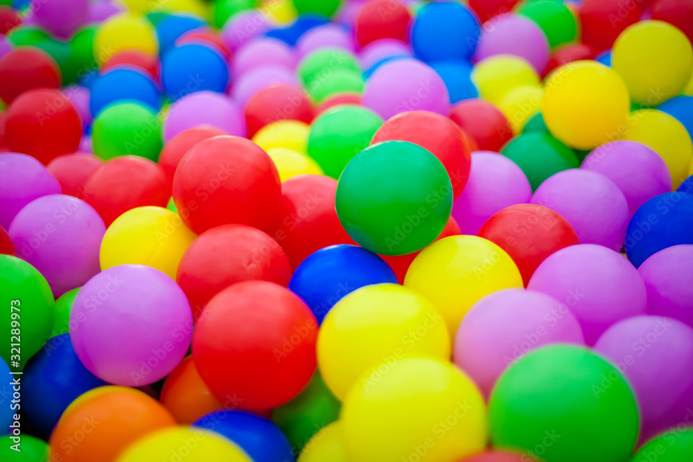 Close-up of multi-colored bright round plastic balls in large numbers. Background for children's holiday. Children's birthday Close-up of multi-colored bright round plastic balls in large numbers. Background for children's holiday. Children's birthday