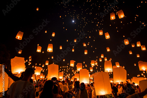 Lanna Dhutanka, Chiang Mai, Thailand - November 11, 2019: People floating lanterns to the sky in Loy Krathong Festival or known as Yi Peng Lantern Festival. photo