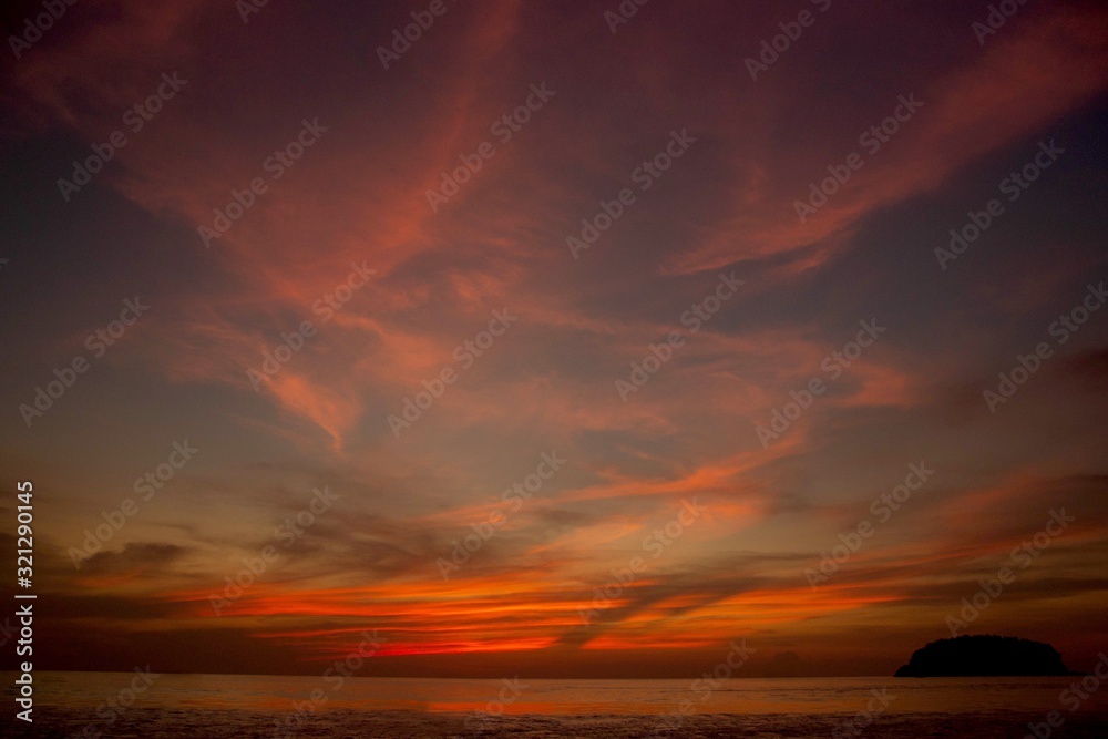 Dramatic sunset on the sea. Beautiful sky and clouds at sunset.