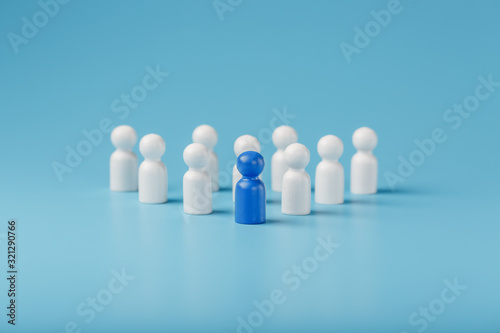 Blue leader the leader leads a group of employees in white to achieve the goal, personnel, and recruitment. The concept of leadership.