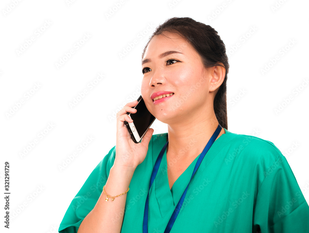 Asian Korean woman as successful physician talking on hand phone - young beautiful and happy medicine doctor or hospital nurse in green medical scrubs smiling Asian Korean woman as successful physician talking on hand phone - young beautiful and happy medicine doctor or hospital nurse in green medical scrubs smiling