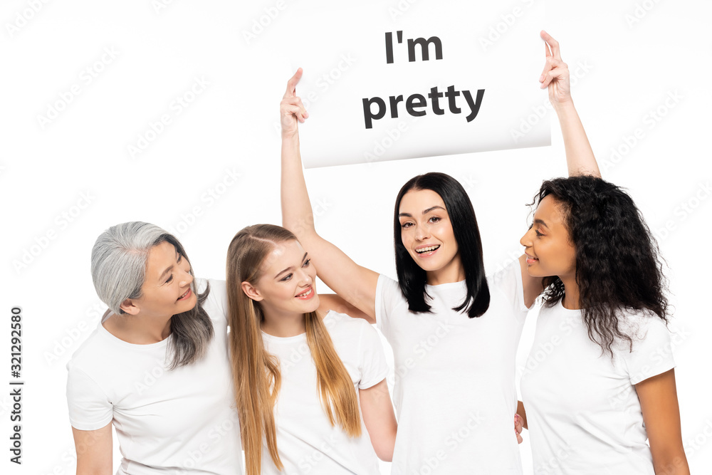 four multicultural women near placard with i`m pretty lettering isolated on white four multicultural women near placard with i`m pretty lettering isolated on white