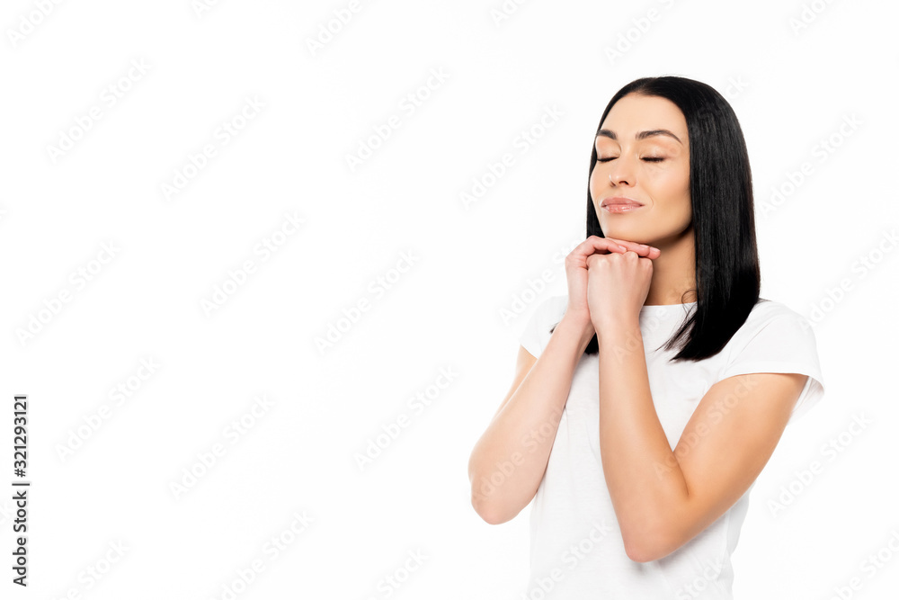 attractive woman with closed eyes and clenched hands isolated on white attractive woman with closed eyes and clenched hands isolated on white