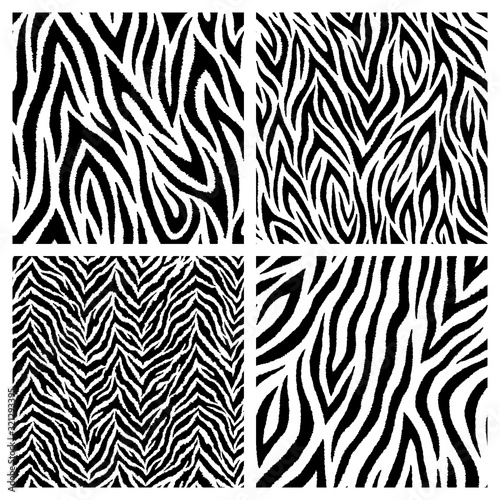 Set of 4 black and white zebra skin imitation seamless patterns. Vector wallpapers. Exotic wild animalistic skin textures.