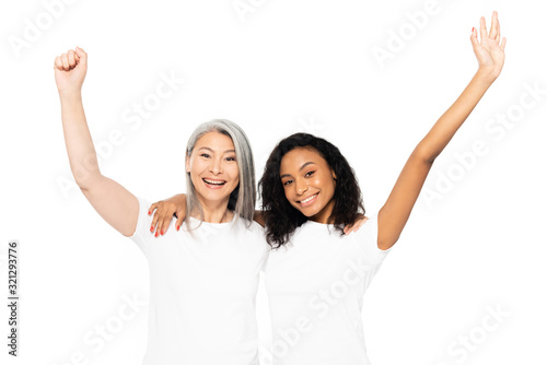 smiling multicultural women celebrating triumph isolated on white