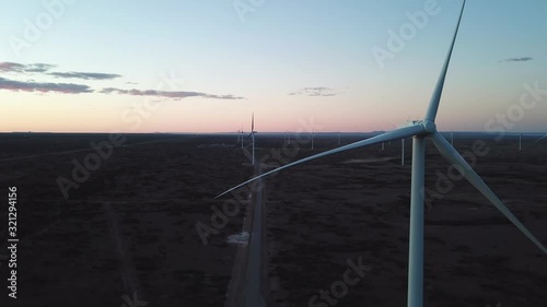 Dramatic Aerial View of Wind Turbune Array Without Movement in Plain Field in Twilight. Motionless Blades Close Up Pan photo