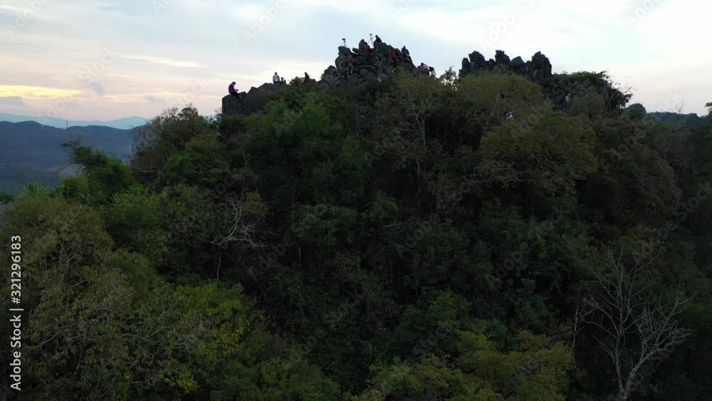 group of unidentified tourist  watching beautiful nature view during sunrise on top of mountain
