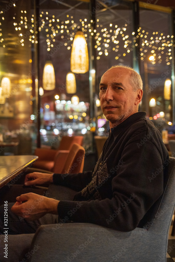 man in a cafe in the evening man in a cafe in the evening