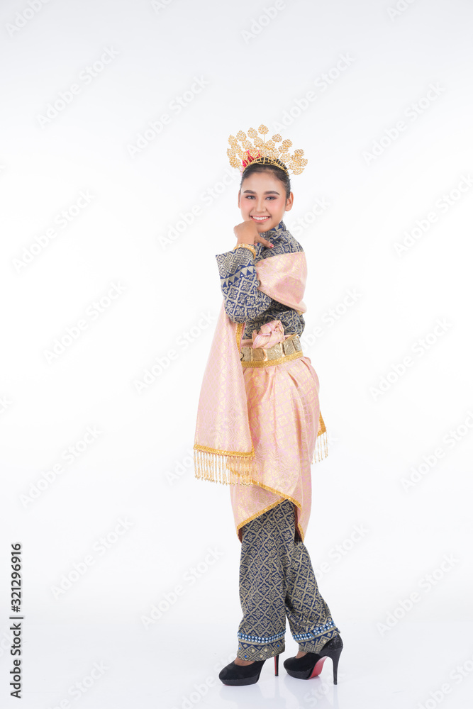 A beautiful Malaysian traditional female dancer performing a cultural dance routine called Tarian Joget in a traditional dance outfit. Full length isolated in white.