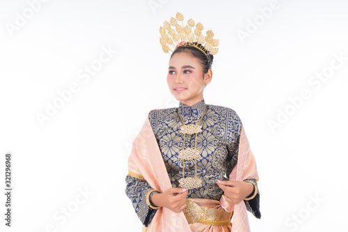 A beautiful Malaysian traditional female dancer wearing traditional dance outfit. Half length portrait isolated in white. Landscape orientation. photo