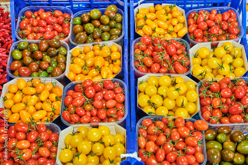 Cherry tomatoes in different colors for sale at a market