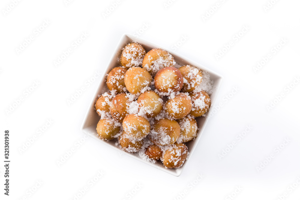Carnival fritters or buñuelos de viento in bowl for holy week isolated on white background. Top view