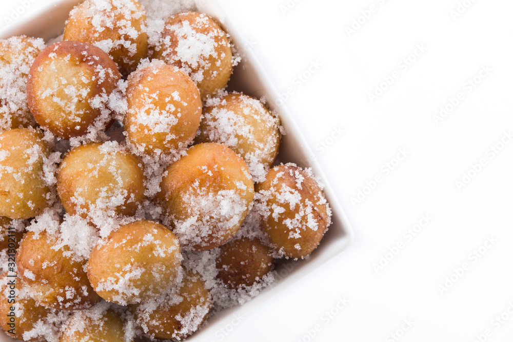 Carnival fritters or buñuelos de viento in bowl for holy week isolated on whiop view. Copy spacete background. T Carnival fritters or buñuelos de viento in bowl for holy week isolated on whiop view. Copy spacete background. T