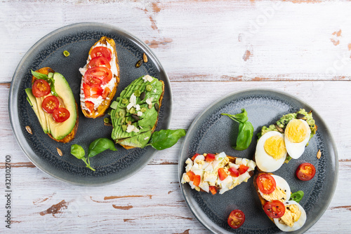 Sweet potato toasts with avocado, eggs, tomatoes and sesame seeds