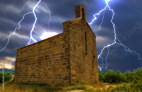 Storm rays in an abandoned hermitage in Navarra photo