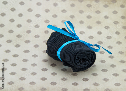 black socks rolled up on a colored background